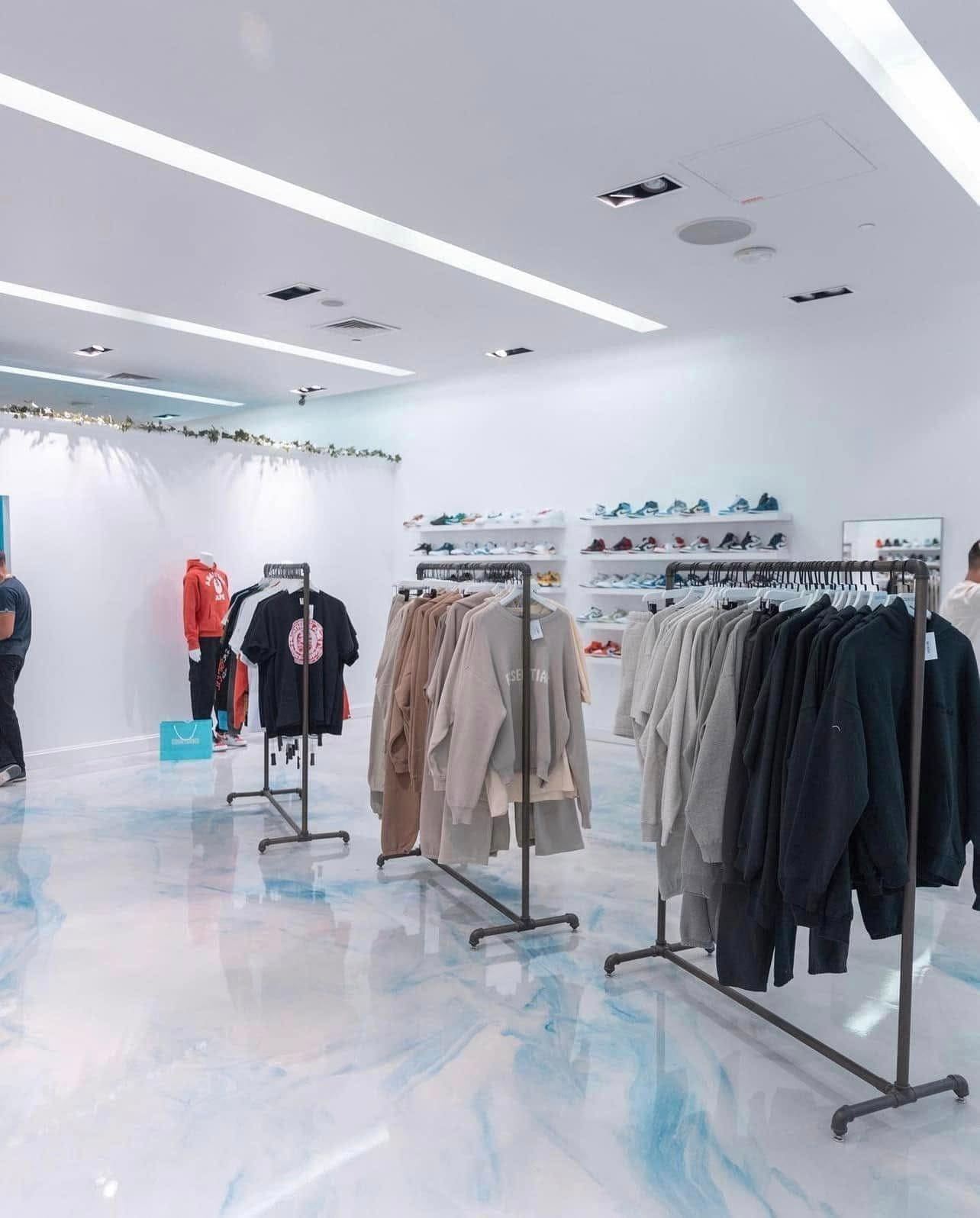 Retail clothing store with a white and blue marbled epoxy floor
