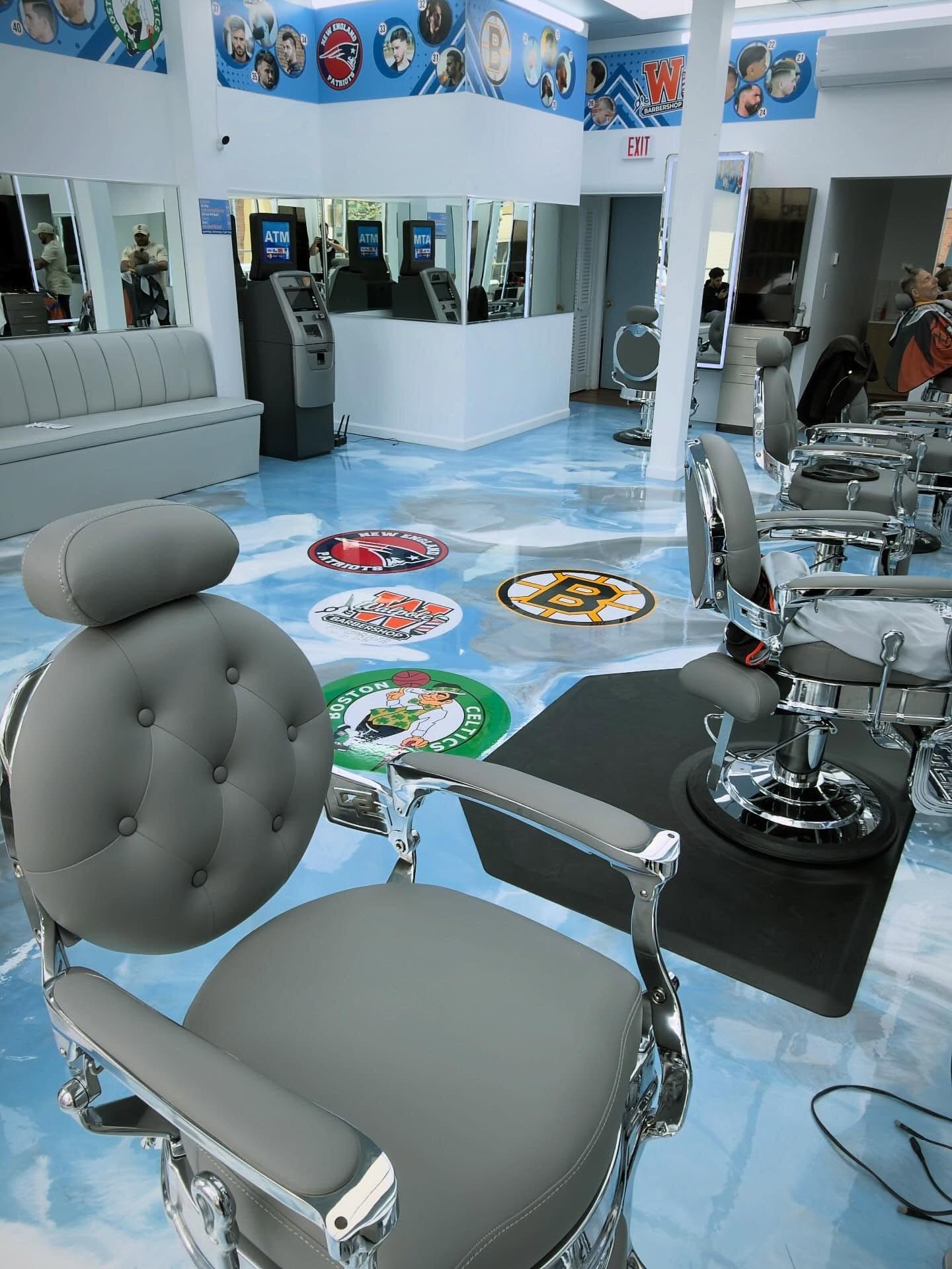 Barbershop interior with a light blue metallic epoxy floor and inlaid graphics