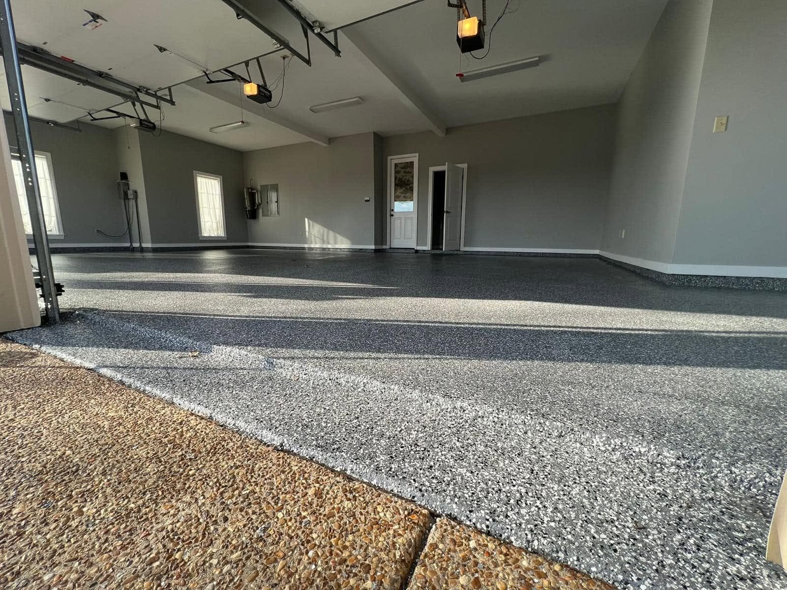 Large garage finished with a grey and white flake epoxy floor