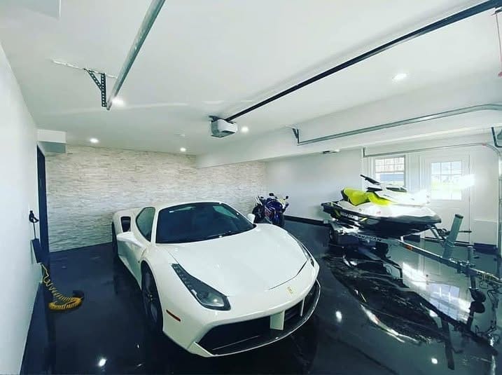 Garage with a black gloss epoxy floor, sports car and jet ski