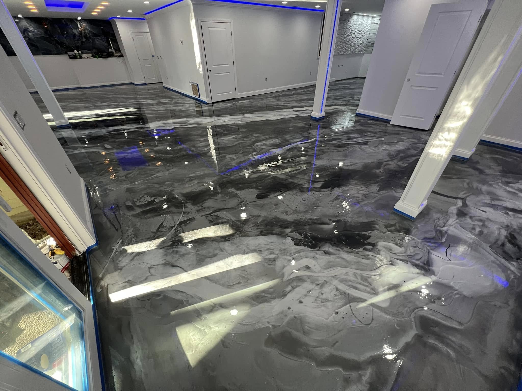 Finished residential basement with a dark silver metallic epoxy floor